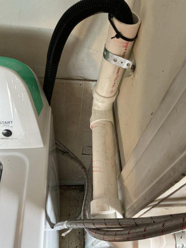 Extended washing machine drain line from current location to connect with the main drainage system. Installed PVC piping with secure metal bracket and connected flexible corrugated hose to ensure proper drainage. System was tested and confirmed to be functioning correctly.