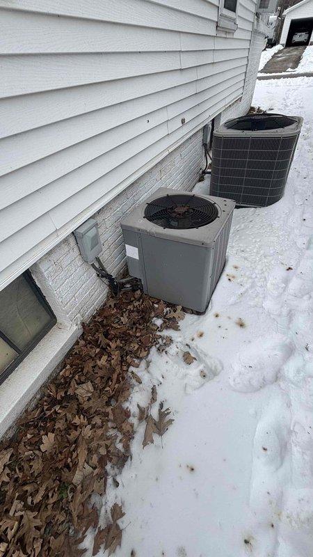 Conducted a comprehensive replacement estimate for two aging exterior HVAC condensing units positioned against the home's foundation. Visual inspection revealed units installed on a narrow strip between the house and yard with accumulated debris around the base. Electrical connections and disconnect switches were documented for proper replacement planning. Customer was present during the entire assessment process.