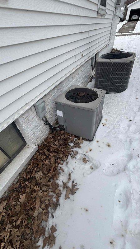 Conducted a comprehensive replacement estimate for two aging exterior HVAC condensing units positioned against the home's foundation. Visual inspection revealed units installed on a narrow strip between the house and yard with accumulated debris around the base. Electrical connections and disconnect switches were documented for proper replacement planning. Customer was present during the entire assessment process.