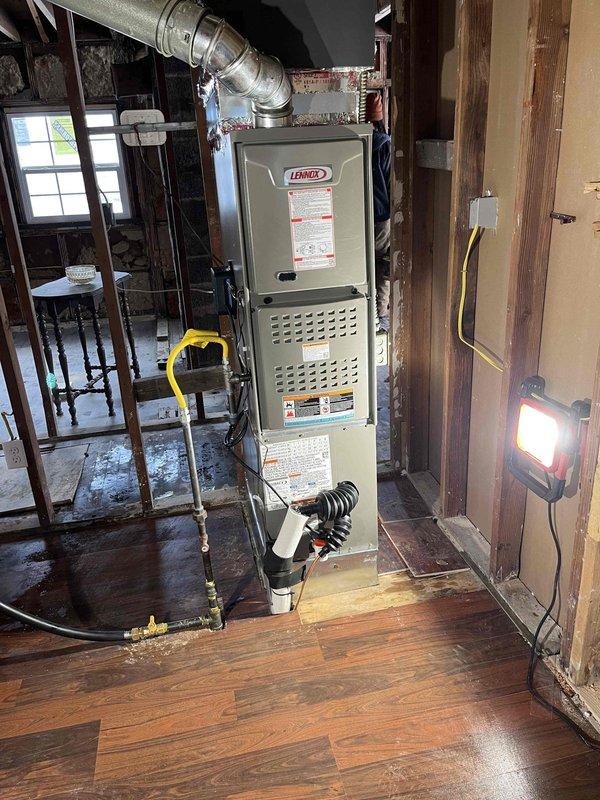Successfully installed a complete Lennox HVAC system in client's basement mechanical area. System includes new furnace with proper gas line connection, ductwork installation, and condensate drainage setup. All components were properly secured and connected according to manufacturer specifications.