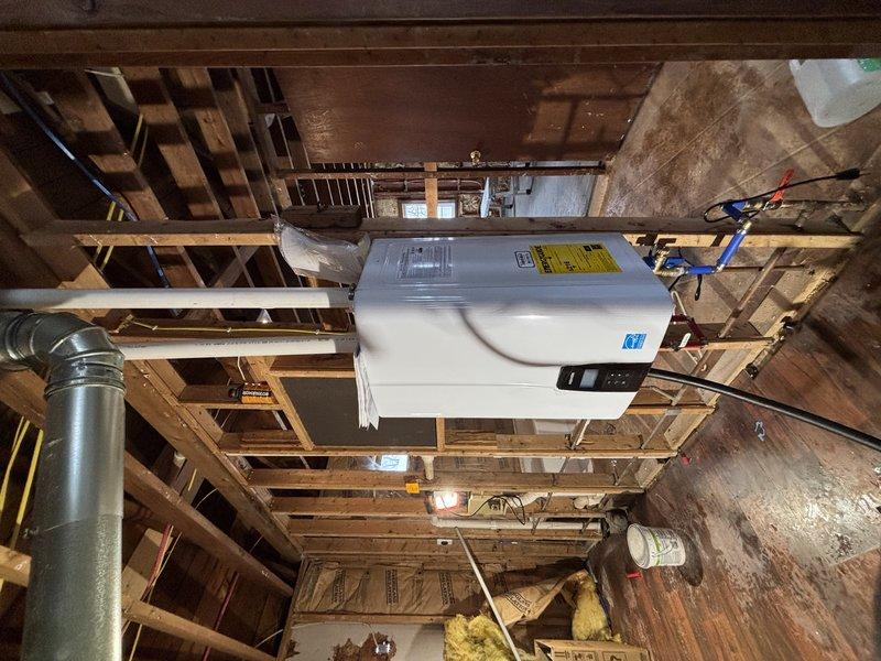 Completed installation of a tankless water heater system in unfinished basement, along with new sink, toilet, and faucet fixtures. Work included proper mounting of the tankless unit to wall framing, connecting necessary electrical wiring, and installing PVC drainage piping with appropriate venting. All components were tested for proper operation before completion.
