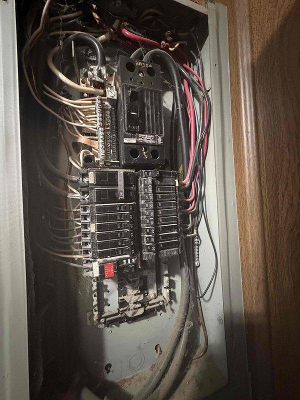 Responded to service call for customer experiencing breaker trips causing system cycling and blower malfunction. Inspected electrical panel, which showed signs of aging with multiple circuit breakers (20-50 amp range). Visual examination revealed disorganized wiring and possible corrosion in the breaker box that was likely causing the intermittent power issues affecting the HVAC system operation.