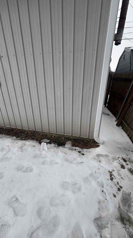 Conducted a mini-split system addition estimate for client's property currently under construction. Inspected framing area with exposed insulation to determine optimal unit placement. Evaluated exterior wall conditions for potential condenser location, noting adequate clearance and proper drainage considerations with existing snow conditions.