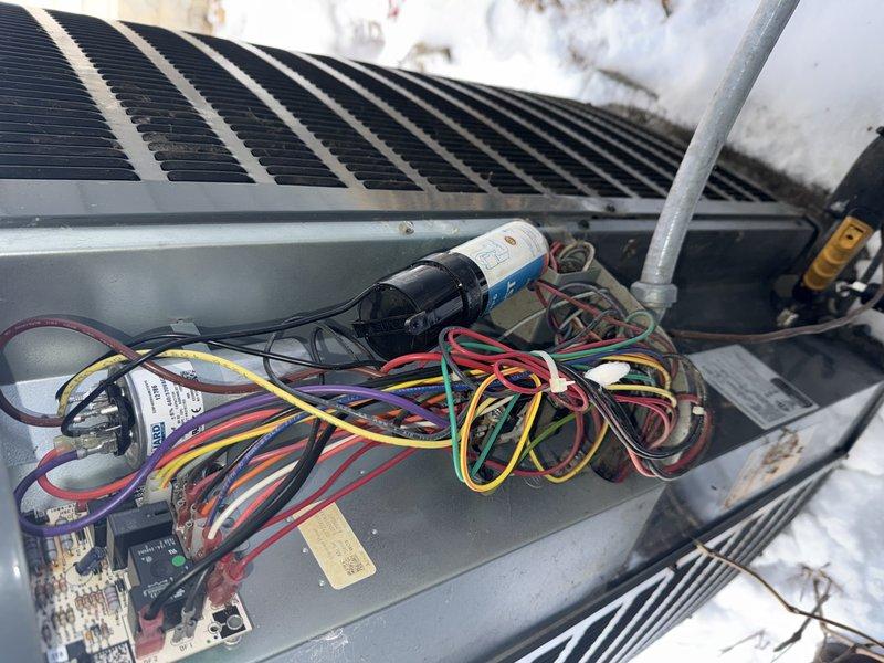 Responded to customer complaint regarding loud noise from outdoor unit and insufficient heating. Conducted diagnostic inspection of HVAC system, examining internal electrical components including wiring connections and circuit boards. Performed electrical testing using multimeter to identify potential issues with system operation. Troubleshooting completed to address the noise and heating performance concerns.