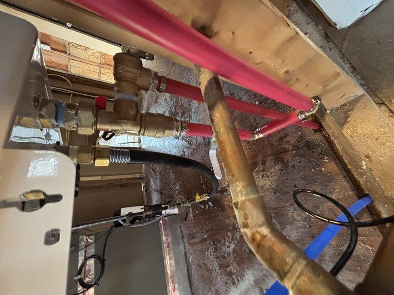 Completed installation of a RED tankless water heater system with associated plumbing components. Installed new sink, toilet, and faucet fixtures as specified in the service order. Work included connecting PEX supply lines with appropriate brass valves and fittings, and ensuring proper drainage through PVC waste lines with P-trap configuration. All installations were pressure tested and confirmed operational.