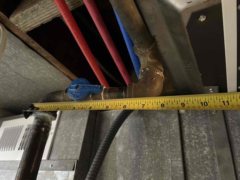 Conducted follow-up inspection of reported gas piping leak. Took measurements of copper pipe junction with blue valve handle and adjacent piping system to assess replacement needs. Identified oxidation and slight corrosion at joint areas requiring attention. Documentation completed with measurements for proper replacement parts.