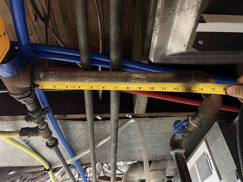 Conducted follow-up inspection of reported gas piping leak. Took measurements of copper pipe junction with blue valve handle and adjacent piping system to assess replacement needs. Identified oxidation and slight corrosion at joint areas requiring attention. Documentation completed with measurements for proper replacement parts.