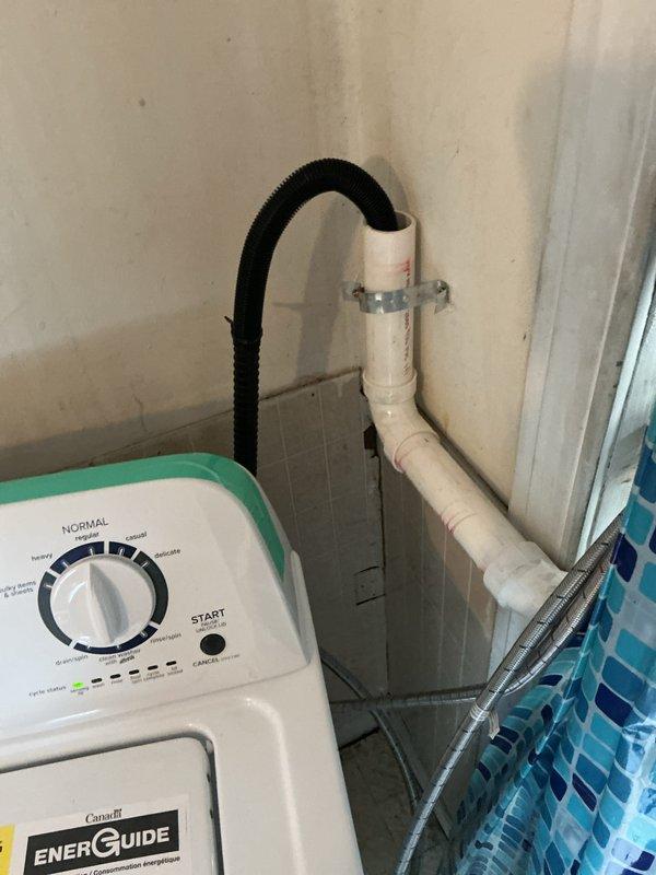 Responded to service call for washer hook-up completion. Installed PVC drainage system with proper wall mounting and connected washing machine drain hose. Completed water supply installation using flexible braided lines with brass fittings secured to wall. System is now operational with water service restored.