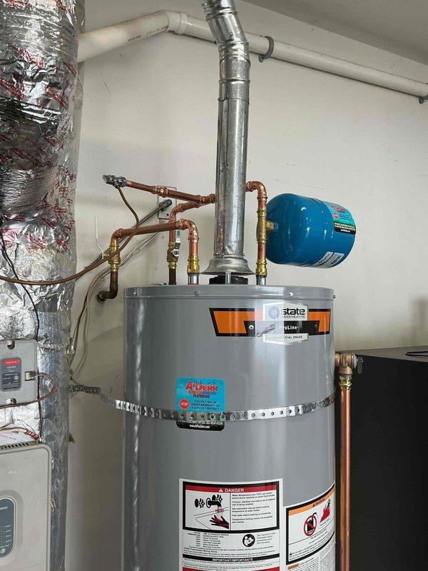 Successfully installed a new State water heater with complete replacement of stand, shut-off valve, and copper supply lines as requested. Relocated and installed new expansion tank per previous agreement. All connections verified secure with proper fittings and no leaks observed during final inspection.