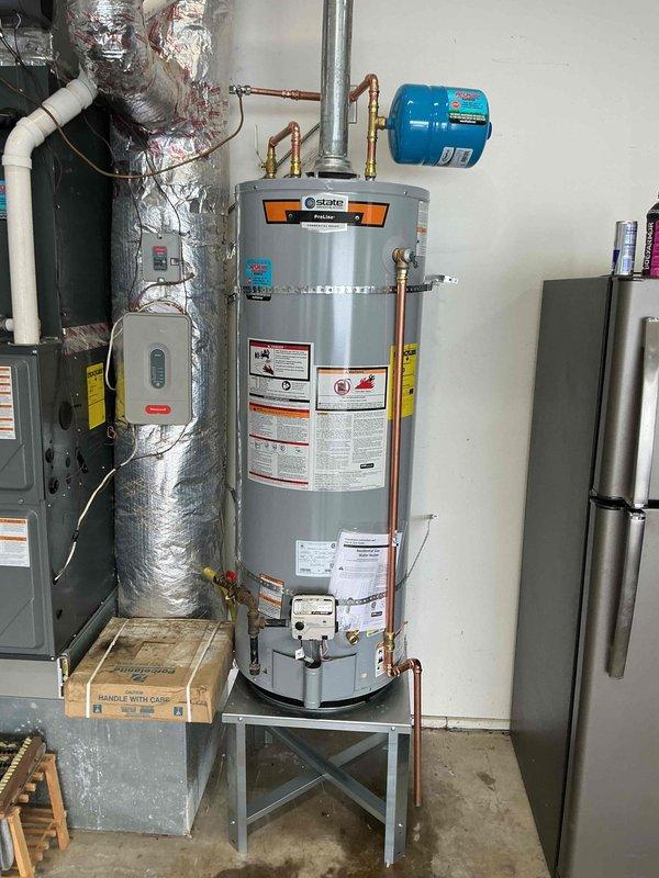 Successfully installed a new State water heater with complete replacement of stand, shut-off valve, and copper supply lines as requested. Relocated and installed new expansion tank per previous agreement. All connections verified secure with proper fittings and no leaks observed during final inspection.