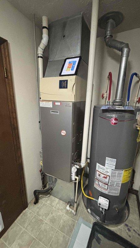 Conducted comprehensive inspection of existing HVAC system for replacement estimate. Current installation includes standard efficiency furnace with PVC exhaust venting and connected water heater system. Documented equipment condition and space configuration to prepare appropriate sizing and installation requirements for new high-efficiency system.