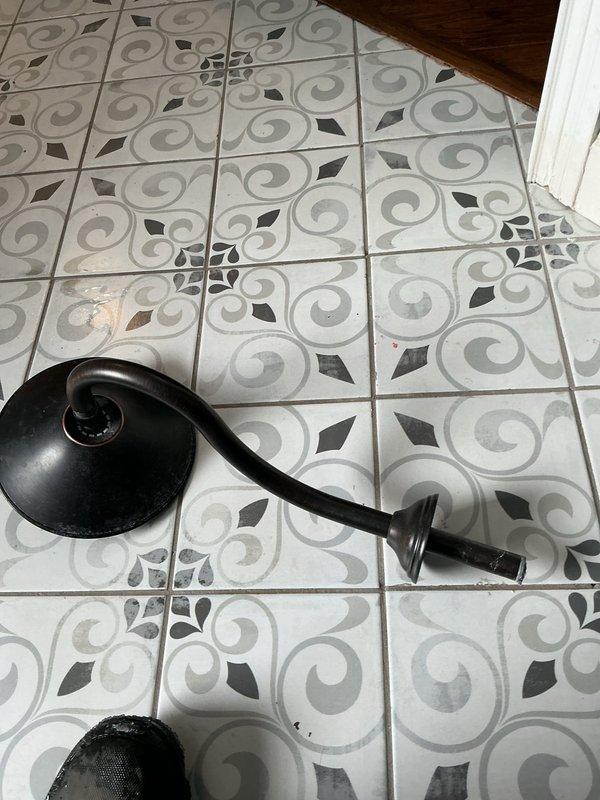 Performed leak search inspection in bathroom area. Located copper supply line within wall cavity requiring access through EdgeGuard moisture barrier. Utilized drain snake to investigate potential blockage in floor drain. Visual inspection revealed minor water spots/staining on decorative tile flooring, possibly indicating intermittent leakage. Further repair recommendations provided to customer.