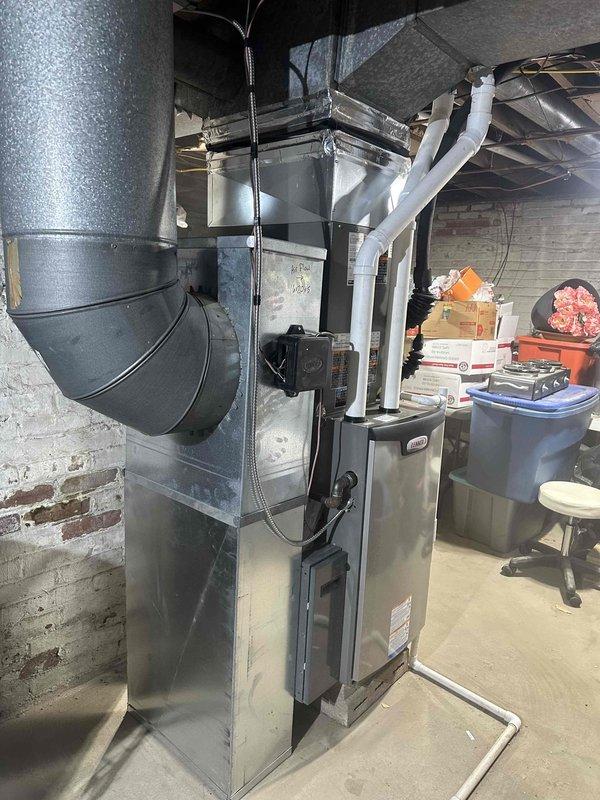 Completed installation of a 2-ton 15.5 SEER 97% efficient system in Boonville as sold by Brookman. System includes a high-efficiency furnace with PVC venting and properly connected ductwork. All components were securely installed in the basement utility area with appropriate electrical connections and drainage setup.