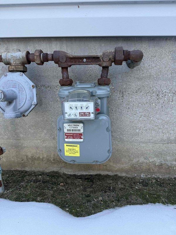 Completed electrical estimate for a generator installation at residential property with natural gas service. Assessment included evaluation of existing service panel (showing signs of aging) and gas meter installation (exhibiting rust on connecting pipes). Documented current electrical capacity and gas supply configuration to determine appropriate generator specifications and installation requirements.