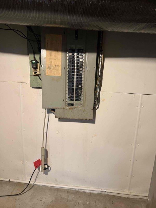 Completed electrical estimate for a generator installation at residential property with natural gas service. Assessment included evaluation of existing service panel (showing signs of aging) and gas meter installation (exhibiting rust on connecting pipes). Documented current electrical capacity and gas supply configuration to determine appropriate generator specifications and installation requirements.