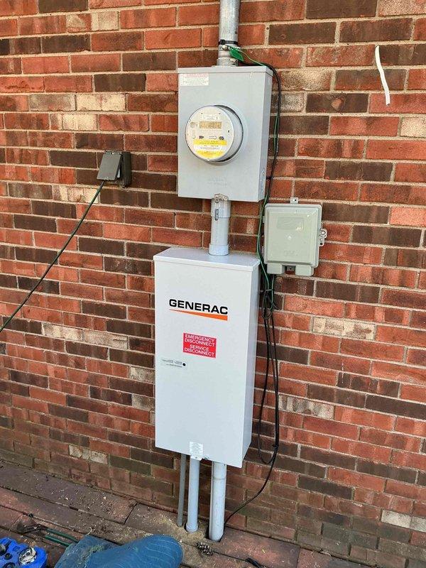 Completed follow-up visit to install 200A Generac automatic transfer switch for generator system. Mounted transfer switch on exterior brick wall adjacent to utility meter, connected necessary conduits and wiring. Integrated system with existing electrical panel in utility room, ensuring proper circuit connections for seamless power transfer capability.