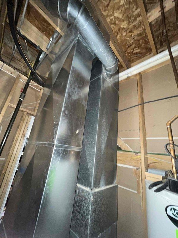 Installed new ductwork system in unfinished basement area to improve ventilation, connecting to existing Carrier HVAC unit. Work included installation of rectangular and circular metal ducts with proper seaming and connections to ensure efficient airflow throughout the space.