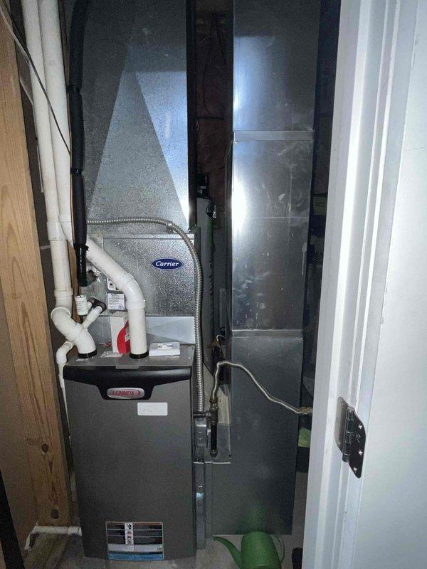 Installed new ductwork system in unfinished basement area to improve ventilation, connecting to existing Carrier HVAC unit. Work included installation of rectangular and circular metal ducts with proper seaming and connections to ensure efficient airflow throughout the space.