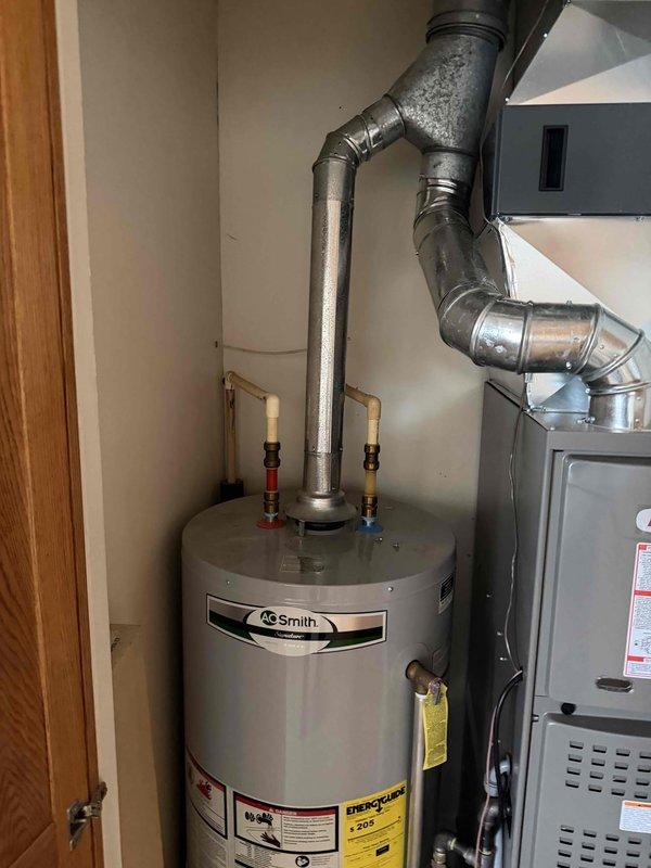 Completed follow-up service to address previously unfinished work. Successfully set A/C system and properly installed ventilation components for AO Smith water heater, ensuring proper connection between the cylindrical duct and rectangular plenum in the ceiling area. Verified all connections were secure and system was functioning correctly.