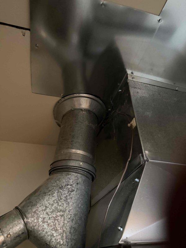 Completed follow-up service to address previously unfinished work. Successfully set A/C system and properly installed ventilation components for AO Smith water heater, ensuring proper connection between the cylindrical duct and rectangular plenum in the ceiling area. Verified all connections were secure and system was functioning correctly.