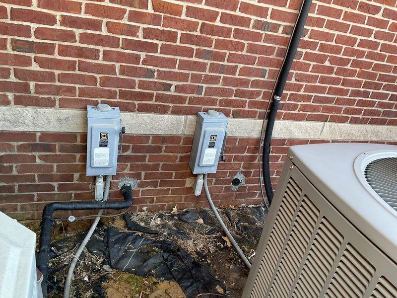 Conducted comprehensive assessment of two aging outdoor HVAC units mounted on concrete base adjacent to brick exterior wall. Units showed signs of deterioration requiring replacement, with visible Schneider-branded system and secondary white unit both evaluated. Documented electrical connections including disconnect boxes and conduit configuration for proper replacement planning. Customer (Tonya) confirmed non-operational system status and expressed interest in replacement options only, not repairs.