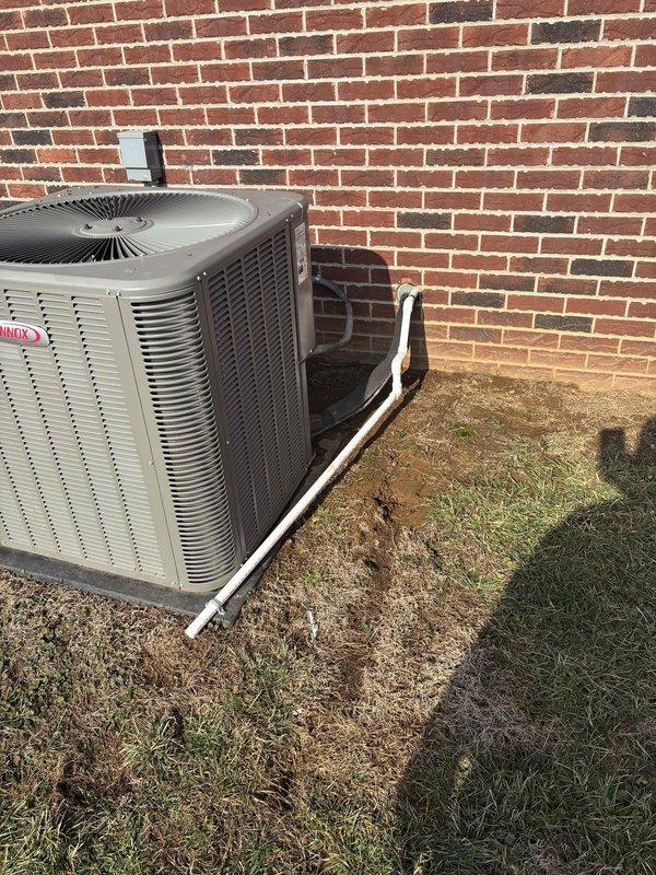 Redirected and connected the furnace condensate drain line to the under-house plumbing system instead of discharging outside. Verified proper installation of the Lennox outdoor unit and documented the completed work with photos.