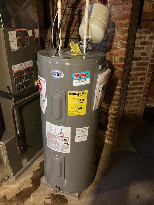 Inspected existing Richmond water heater installation in basement utility area. System appears to be a standard tank-type water heater with proper connections including pressure relief valve and expansion tank. Verified all plumbing connections, including PVC and copper piping. System is functioning normally with no apparent leaks or safety concerns.