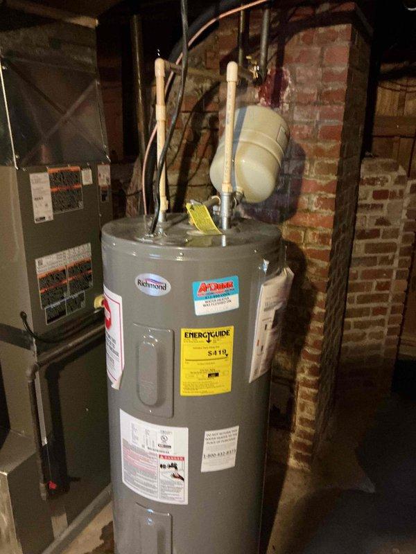 Inspected existing Richmond water heater installation in basement utility area. System appears to be a standard tank-type water heater with proper connections including pressure relief valve and expansion tank. Verified all plumbing connections, including PVC and copper piping. System is functioning normally with no apparent leaks or safety concerns.