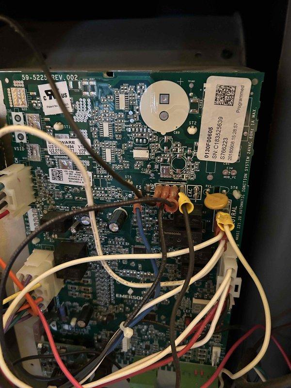 Responded to callback for system with intermittent operation issues previously serviced one month ago. Upon inspection, found control board exhibiting red flickering light and failure to maintain continuous operation. Diagnosed faulty Emerson circuit board (59-522 REV.002) with compromised electronic components. Replaced control board and verified proper system operation with stable ignition sequence and normal runtime performance.