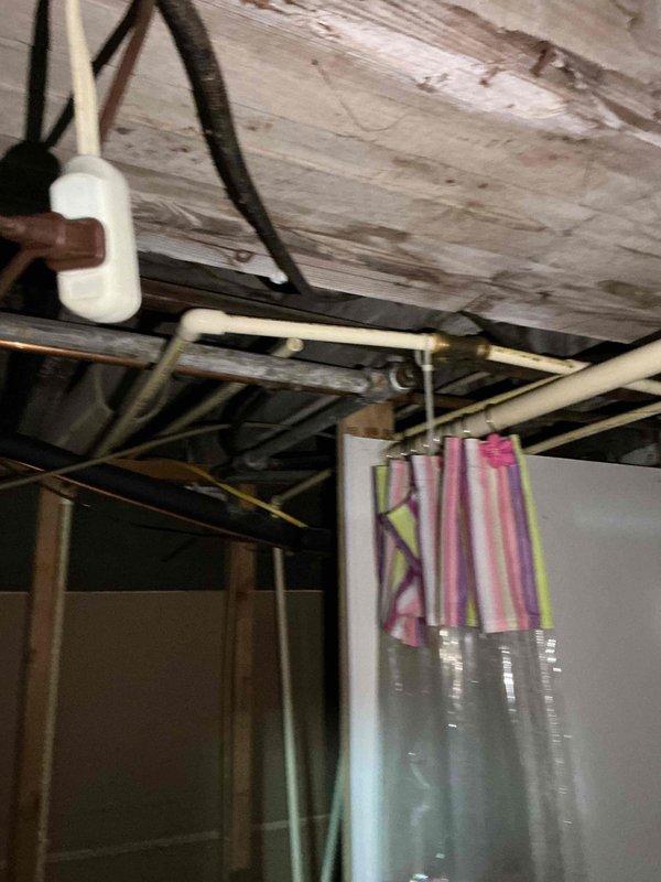 Performed comprehensive inspection of customer's plumbing system to address concerns about water pressure issues and potential water heater replacement. Examined exposed plumbing lines in unfinished basement/crawlspace, noting conditions of copper and PVC piping. Provided customer with water heater replacement options based on assessment findings.