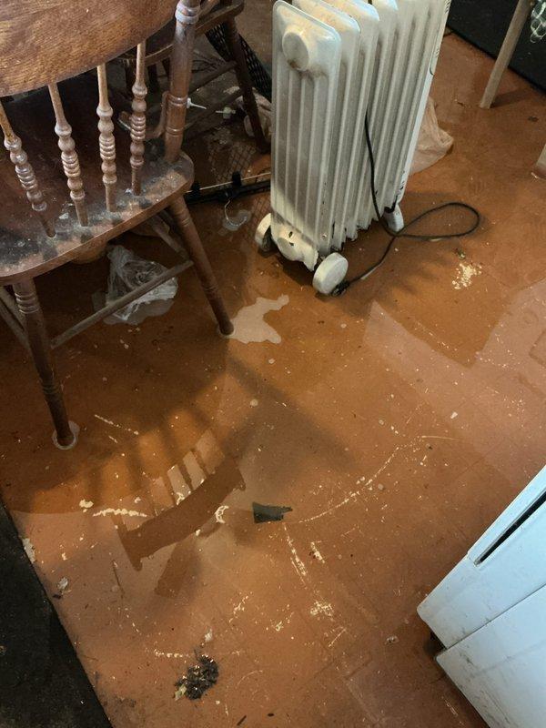 Conducted follow-up inspection regarding previous drainage issue. Documented significant water damage with standing water on kitchen floor. Examined washing machine drain connection system and identified improper discharge from drain hose to PVC pipe as likely cause of continued leakage. Recommended immediate repairs to prevent further water damage to flooring and surrounding structures.