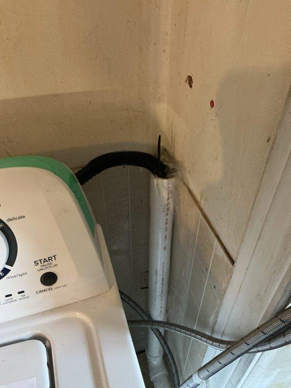 Conducted follow-up inspection regarding previous drainage issue. Documented significant water damage with standing water on kitchen floor. Examined washing machine drain connection system and identified improper discharge from drain hose to PVC pipe as likely cause of continued leakage. Recommended immediate repairs to prevent further water damage to flooring and surrounding structures.