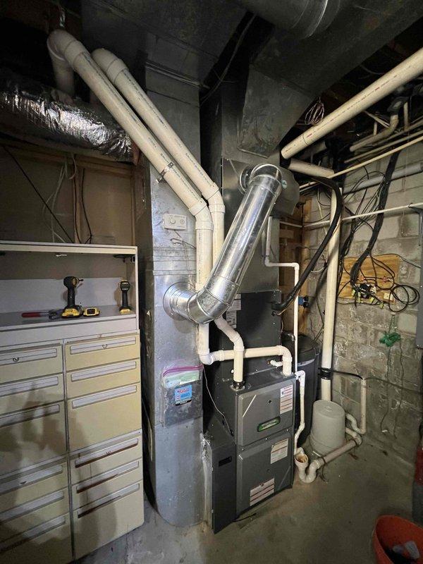 Conducted site assessment for humidifier relocation project, evaluating feasibility of moving unit to hot water line for improved performance. Documented current installation configuration in basement mechanical room and examined potential new mounting locations. Also assessed options for repositioning humidistat to optimize system responsiveness and humidity control.