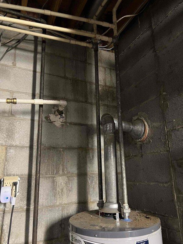 Conducted site assessment for humidifier relocation project, evaluating feasibility of moving unit to hot water line for improved performance. Documented current installation configuration in basement mechanical room and examined potential new mounting locations. Also assessed options for repositioning humidistat to optimize system responsiveness and humidity control.