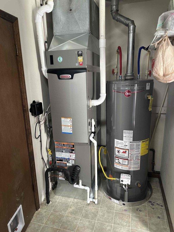 Successfully installed a complete Green2T 18/99 Lennox HVAC system at the Mt Vernon location, including indoor furnace with PVC ventilation and outdoor condensing unit positioned on concrete pad. System was properly connected to existing electrical service and photographed for documentation purposes.