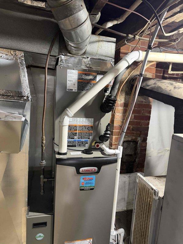 Performed follow-up service visit to complete previously unfinished A/C installation work. Successfully installed and set up Lennox residential HVAC system including indoor furnace unit with PVC ventilation components in utility area and outdoor condensing unit positioned on concrete pad with proper electrical connections. All components properly installed with refrigerant lines connected, system tested, and A/C now operational.