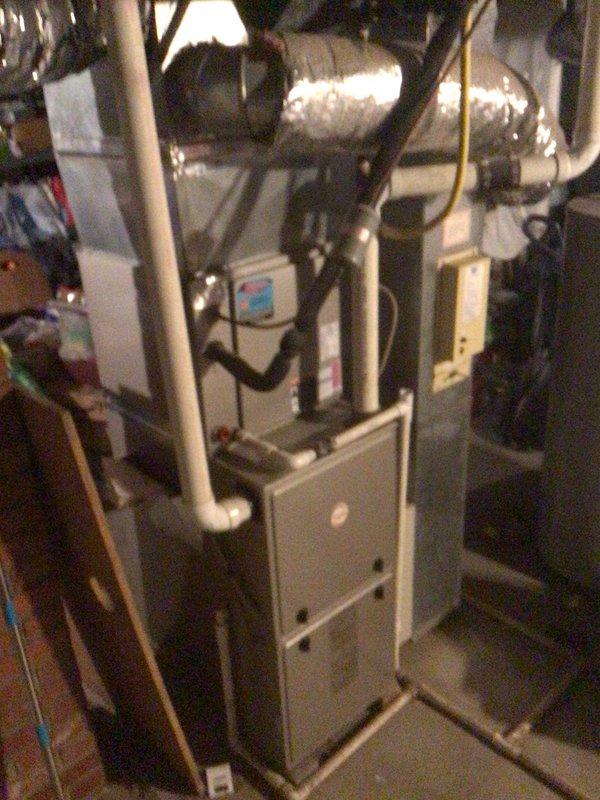 Completed planned maintenance service on residential HVAC system and Generac backup generator. Inspected furnace unit with associated ductwork and drainage components in utility room, noting all connections are secure and properly insulated. Generator unit mounted on concrete pad shows normal weathering but remains in functional condition with electrical connections intact.