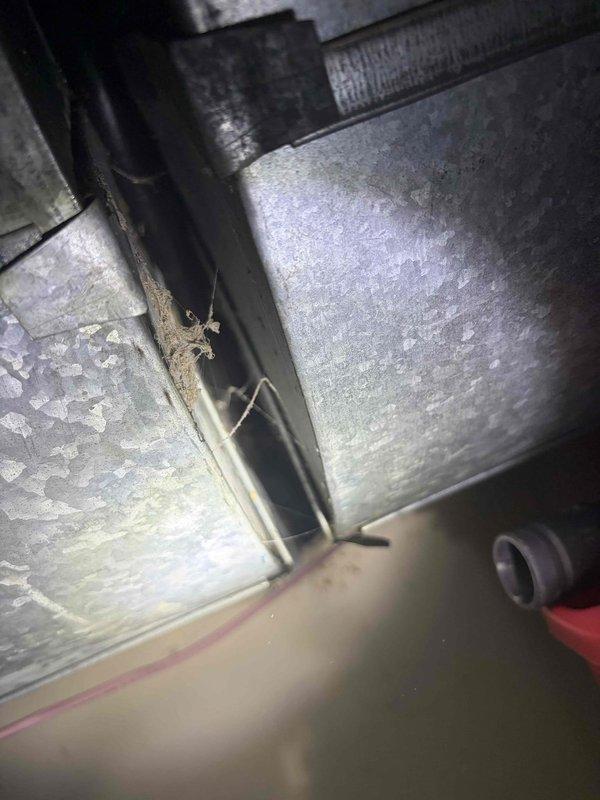 Responded to service call for thermostat issues where system would not shut off. Upon inspection of the ductwork and structural components in the crawlspace, identified loose connections in the metal ductwork junction points which were affecting system operation. Sealed connection points with metal tape and verified proper system cycling after repair.