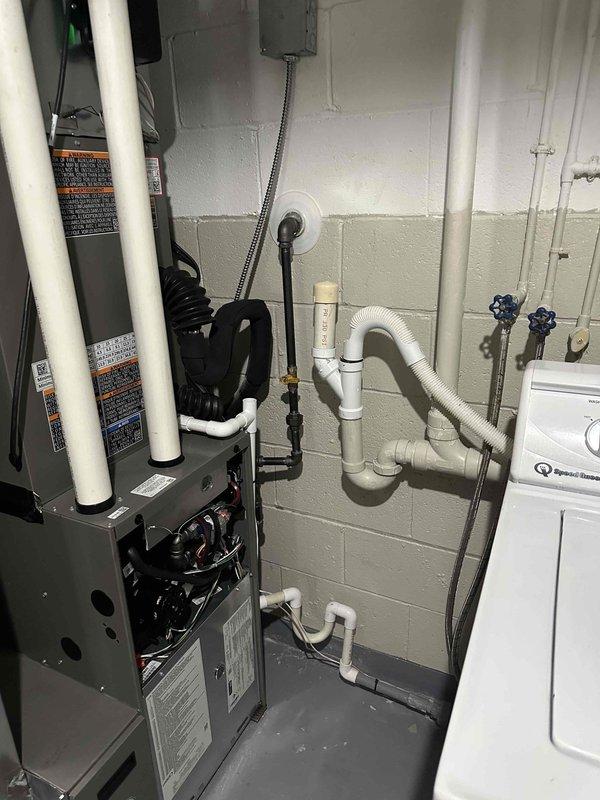 Completed follow-up service to finish gas line installation for previously installed HVAC system. Inspected both indoor furnace unit with PVC ventilation connections and outdoor condensing unit mounted against brick exterior wall. Verified proper gas line connections and electrical wiring to ensure complete system functionality.