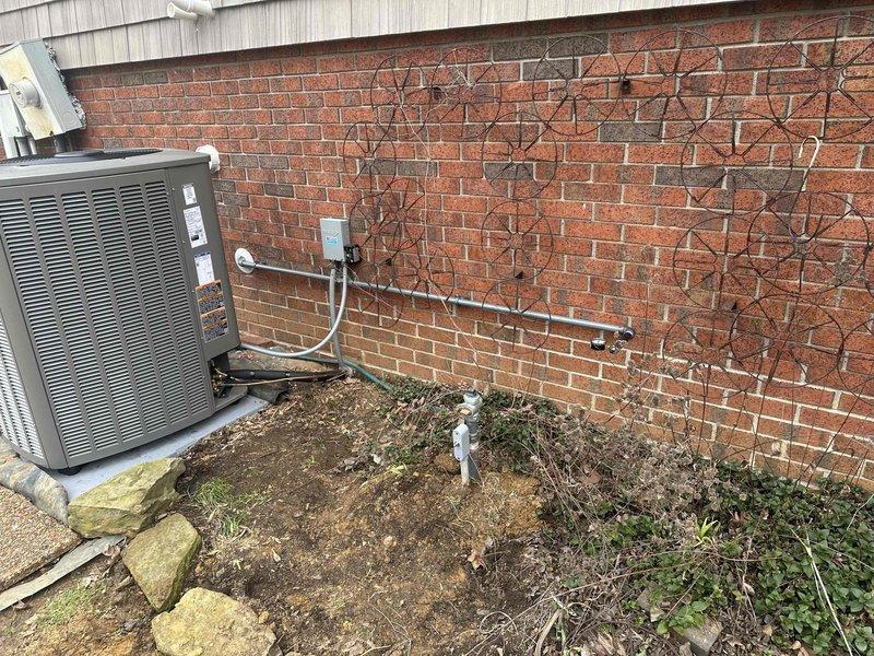 Completed follow-up service to finish gas line installation for previously installed HVAC system. Inspected both indoor furnace unit with PVC ventilation connections and outdoor condensing unit mounted against brick exterior wall. Verified proper gas line connections and electrical wiring to ensure complete system functionality.