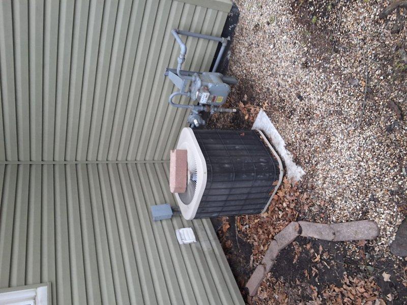 Completed assessment for replacement of aging exterior HVAC condenser unit. Documented current installation on gravel bed adjacent to structure with green siding, noting electrical connections and surrounding conditions. Turned quote over to management for customer consideration.