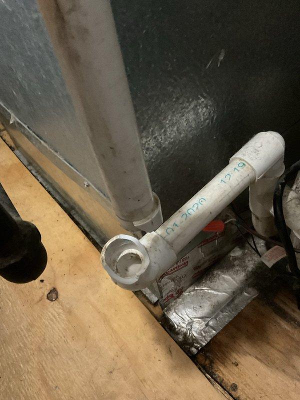 Responded to water leak report in utility room from a 6-year-old HVAC system. Upon inspection, identified a broken pipe on the furnace that had caused significant water release but had mostly stopped leaking at time of arrival. Documented the condition of the drainage pan showing sediment buildup and assessed potential water damage to the surrounding plywood flooring.