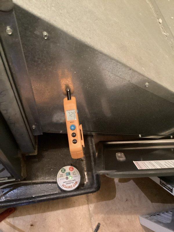 Completed annual platinum maintenance service on HVAC system. Performed temperature measurements with digital probe showing 72.9°F reading and inspected interior components including fan motor assembly, electrical connections (red/white/green/orange wires), and gas valve assembly with 94Z identification. System is functioning within normal parameters and service agreement has been renewed for the upcoming year.