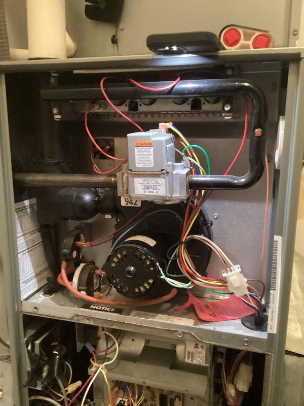 Completed annual platinum maintenance service on HVAC system. Performed temperature measurements with digital probe showing 72.9°F reading and inspected interior components including fan motor assembly, electrical connections (red/white/green/orange wires), and gas valve assembly with 94Z identification. System is functioning within normal parameters and service agreement has been renewed for the upcoming year.