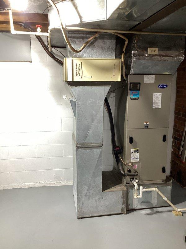 Completed scheduled Gold Level maintenance service on 10-year-old Carrier HVAC system. Inspected basement installation including furnace/air handler unit, electronic air cleaner, and associated ductwork. Examined electrical connections at panel box and verified proper system operation during first maintenance visit of the service agreement.