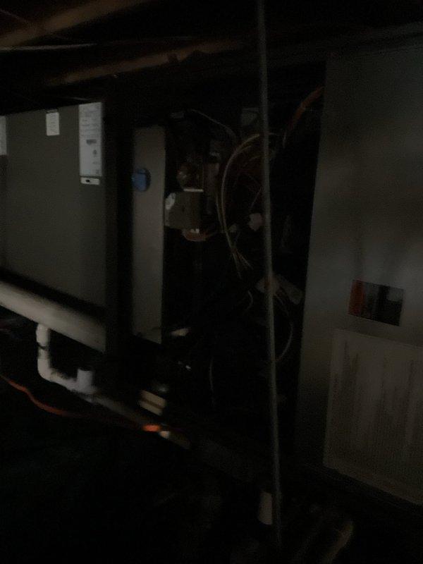 Completed annual Platinum Level maintenance on a 1-year-old HVAC system. Inspected and serviced internal electrical components and connections, including motor assembly and control wiring. Documented system condition with photographs showing the unit installation and interior wiring configuration for service records.