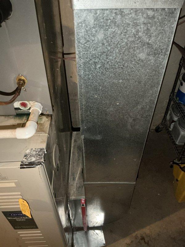 Completed annual maintenance service on a 27-year-old residential HVAC system as part of Gold Level maintenance plan. Inspected the basement-located air handler with attached galvanized sheet metal ductwork and evaluated PVC drain line connections. System showed normal signs of age but is functioning properly with no immediate concerns identified.