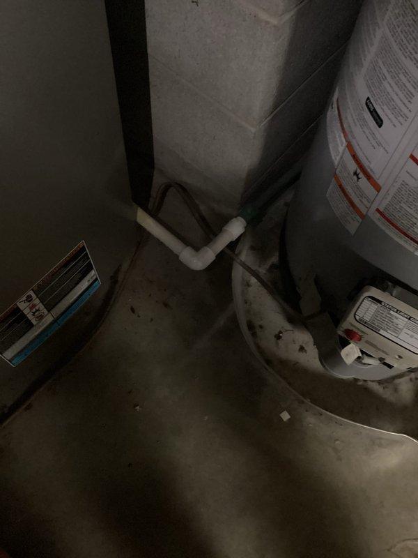 Completed promotional tanked water heater flush service on an A.O. Smith water heater located in utility area. Performed standard maintenance procedure to remove sediment and mineral buildup from tank to improve efficiency and extend equipment life. Documented pre/post service condition with photos showing the unit's installation configuration and proper functioning after maintenance.