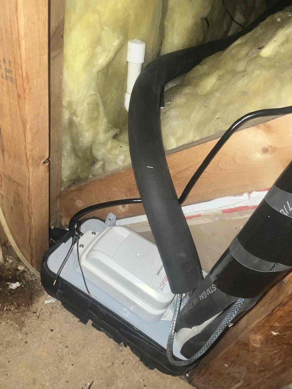 Returned to site to complete drain installation that was pending from previous visit. Accessed the air handler enclosure, inspected the condensate drain system, and properly connected the PVC drain line to the unit. Verified proper routing of the drain line through the insulated wall cavity and ensured secure mounting of all components to prevent future issues.