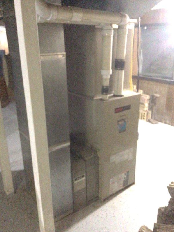 Performed Platinum Level maintenance on 25-year-old HVAC system with 20x25x5 filter. Identified significant water damage/rust staining at structural junction points. System appears functional despite age, with proper ventilation connections and no visible leaks from the furnace unit.